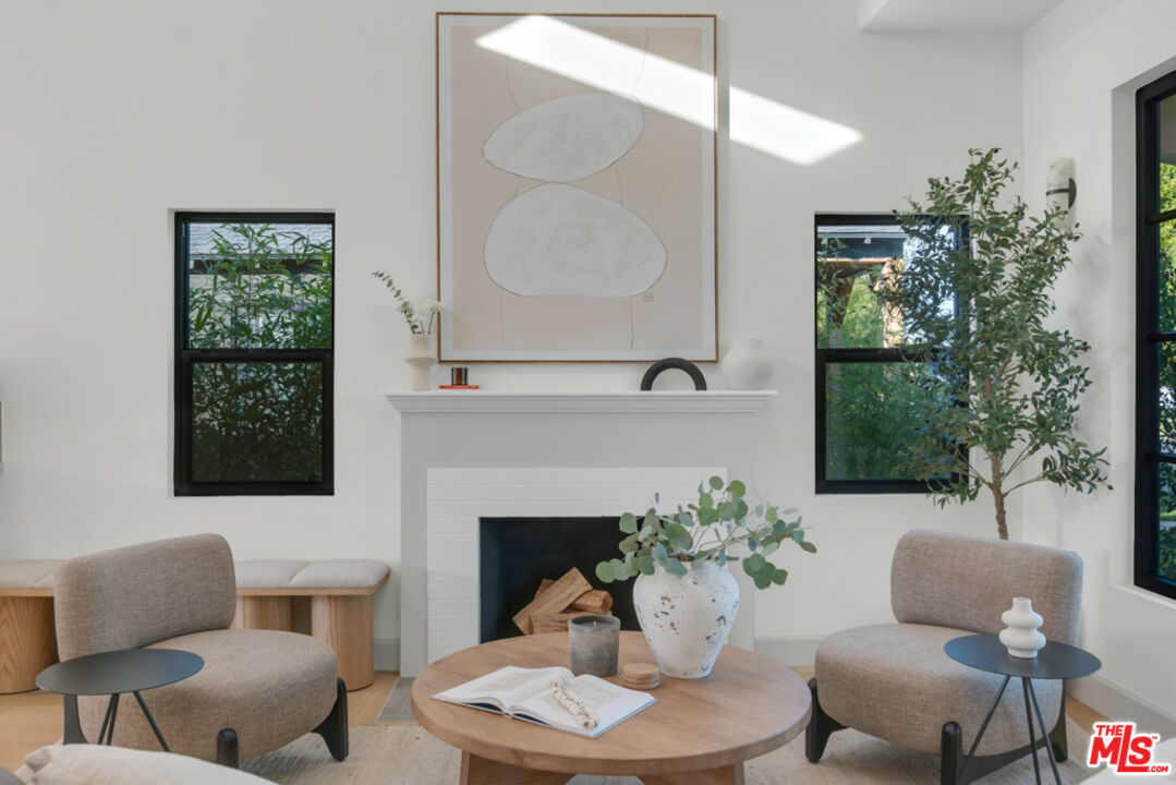 3617 Hillcrest Drive Los Angeles, CA 90016 - Photo 2 of 34 a living room with furniture potted plant and a fireplace