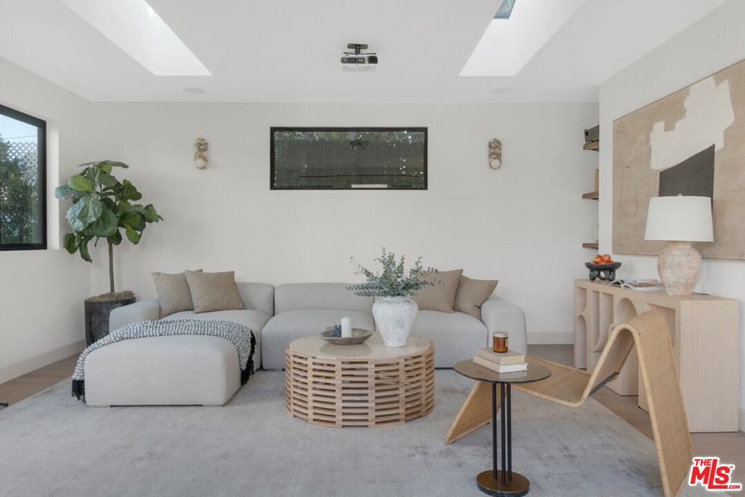 3617 Hillcrest Drive Los Angeles, CA 90016 - Photo 24 of 34 a living room with furniture a flat screen tv and a potted plant