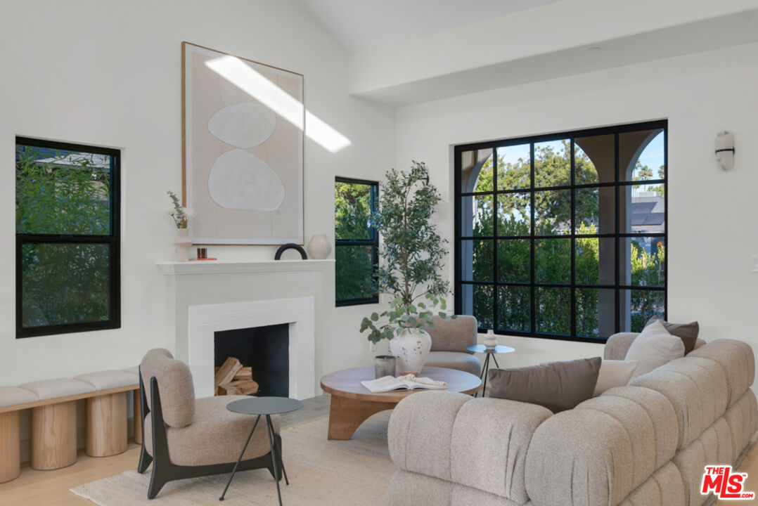 3617 Hillcrest Drive Los Angeles, CA 90016 - Photo 3 of 34 a living room with furniture and a fireplace