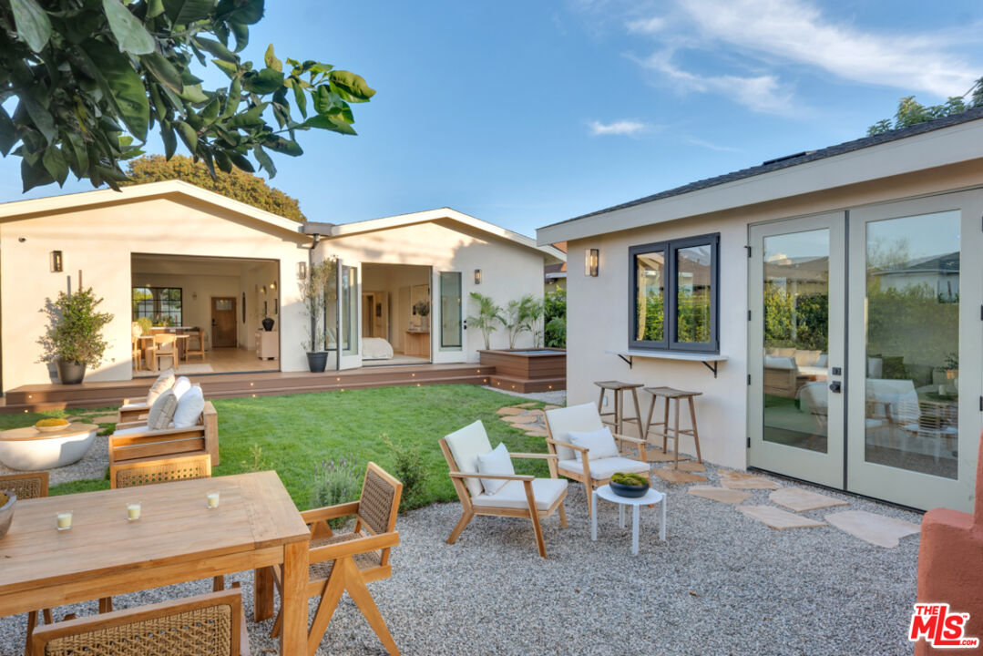 3617 Hillcrest Drive Los Angeles, CA 90016 - Photo 34 of 34 a view of a patio with table and chairs and potted plants