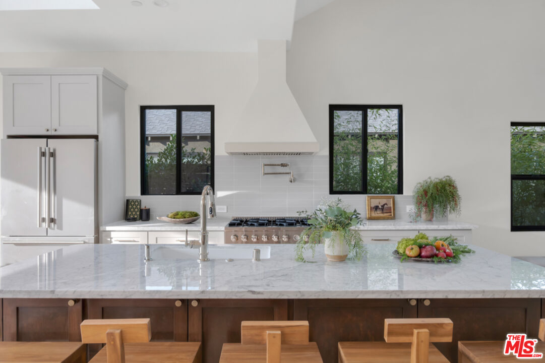 3617 Hillcrest Drive Los Angeles, CA 90016 - Photo 6 of 34 a kitchen with counter top space and windows