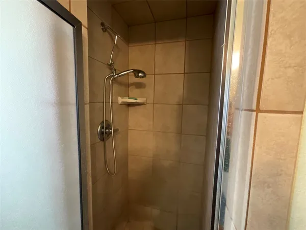 a bathroom with a glass door shower