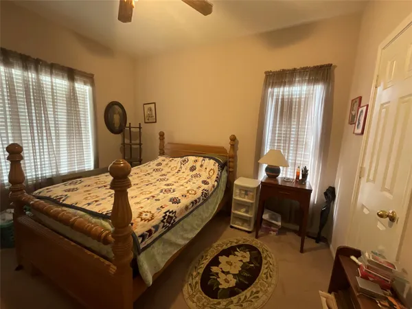 a bedroom with a bed and a table in it