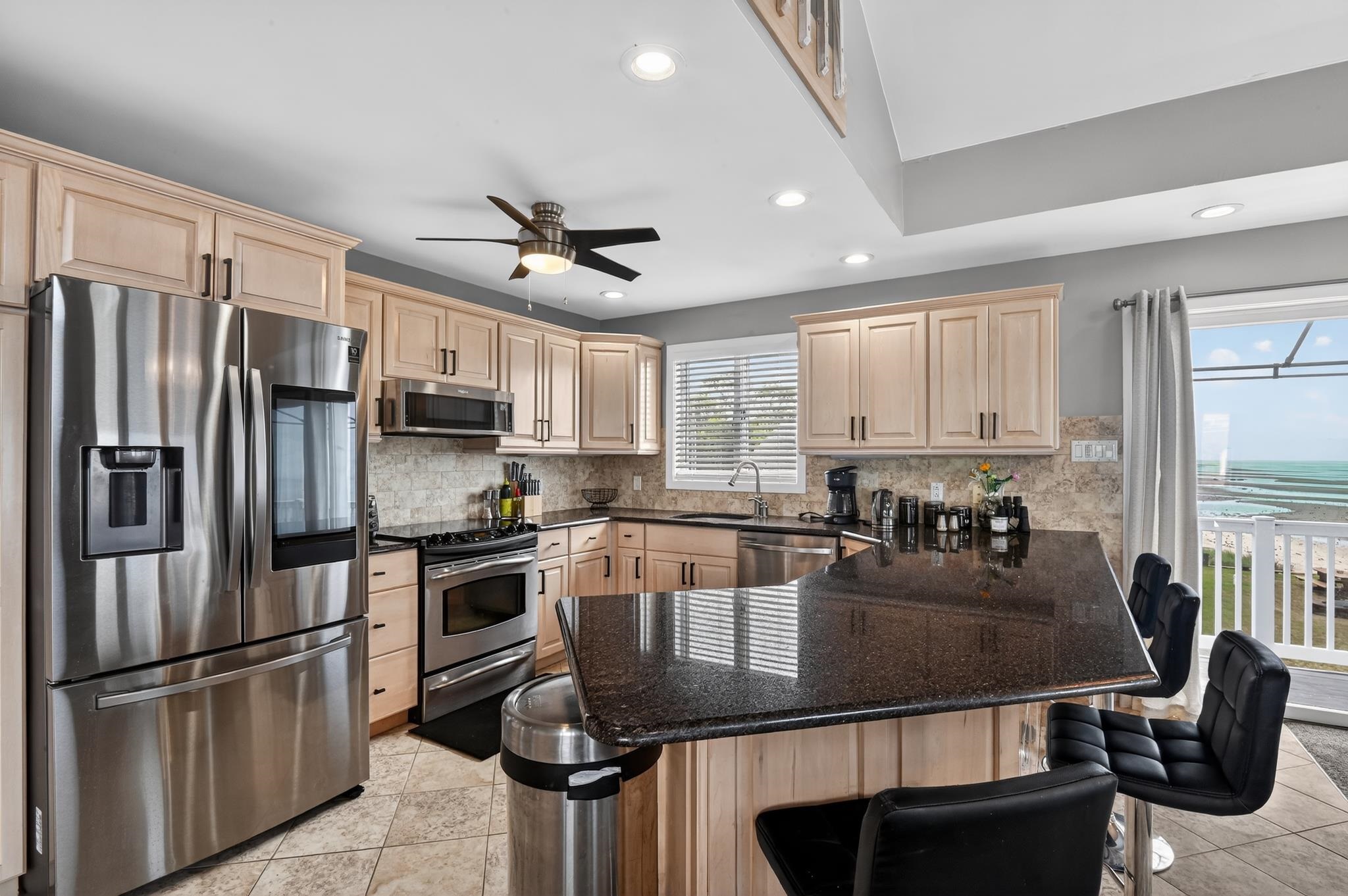 6 Pierces Point Road Cape May Court House, NJ 08210 - Photo 6 of 30 a kitchen with stainless steel appliances granite countertop a sink a stove cabinets counter space and a window