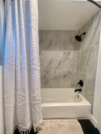 a bathroom with a bathtub and shower