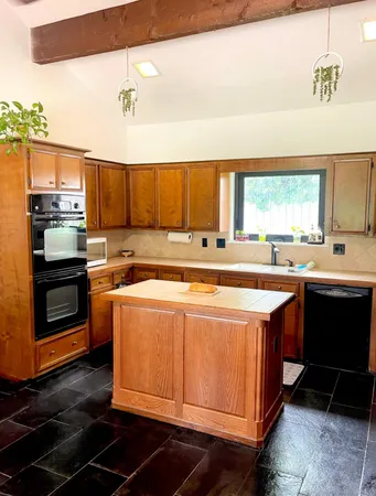 a kitchen with a stove a sink and a microwave