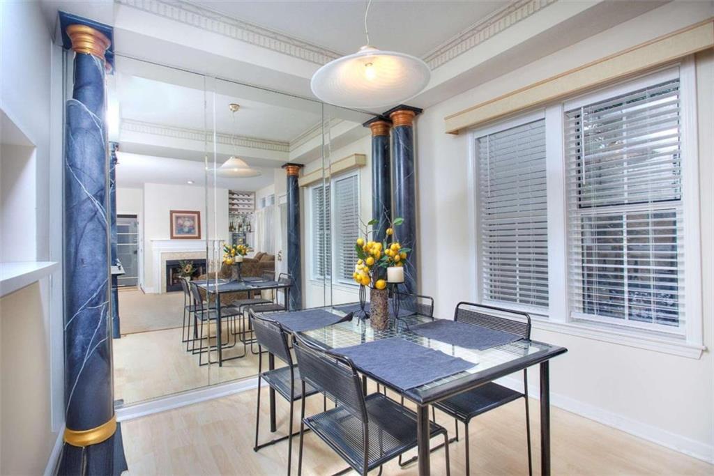 240 Renaissance Parkway Northeast, Unit 116 Atlanta, GA 30308 - Photo 12 of 42 a view of a dining room with furniture and chandelier