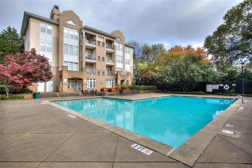 240 Renaissance Parkway Northeast, Unit 116 Atlanta, GA 30308 - Photo 36 of 42 a view of a building with a swimming pool