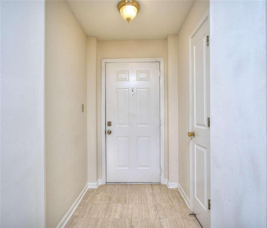 240 Renaissance Parkway Northeast, Unit 116 Atlanta, GA 30308 - Photo 4 of 42 an empty room with wooden floor and windows