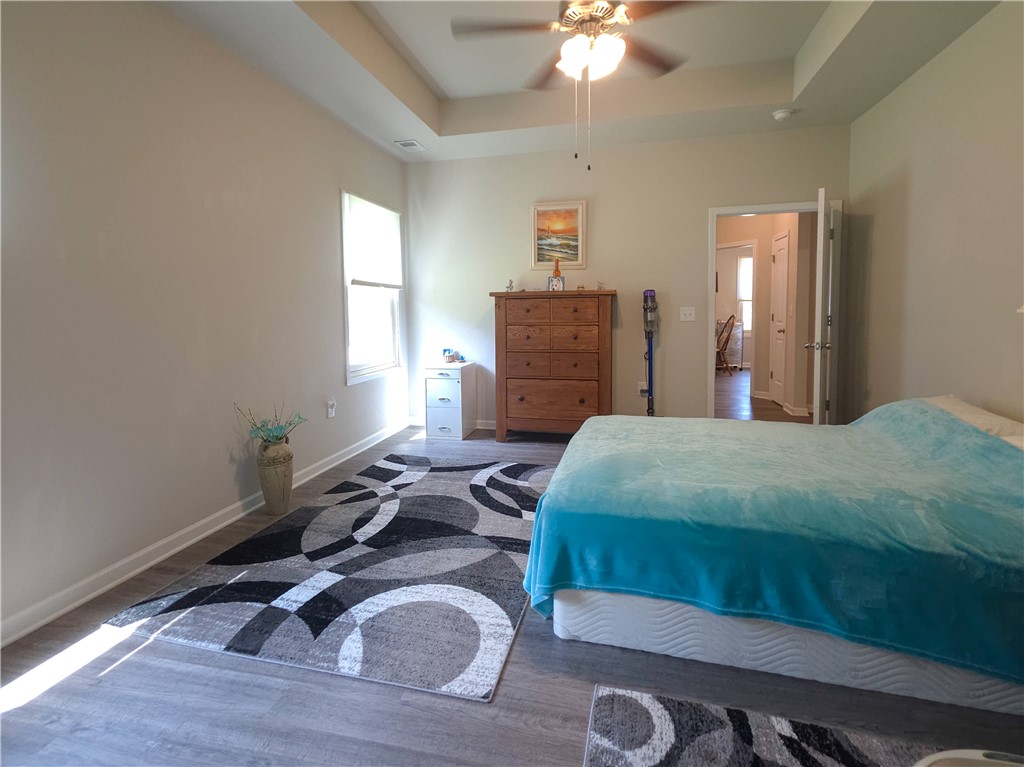 3 Cringle Lane Anderson, SC 29625 - Photo 10 of 26 A tray ceiling and modern flooring define this tranquil bedroom retreat.