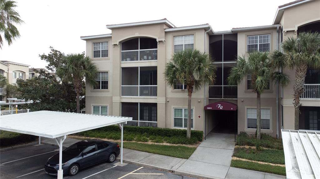 3051 Greystone Loop, Unit 201 Kissimmee, FL 34741 - Photo 20 of 20 a front view of a house with a yard