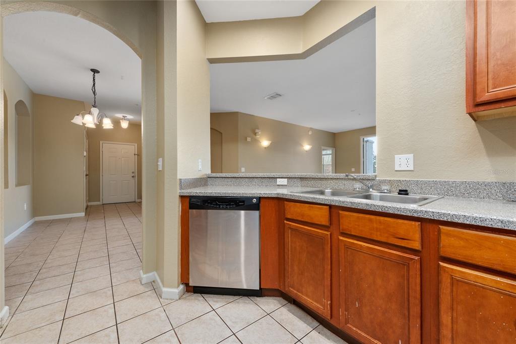 3051 Greystone Loop, Unit 201 Kissimmee, FL 34741 - Photo 8 of 20 a view of a kitchen counter space and chandelier