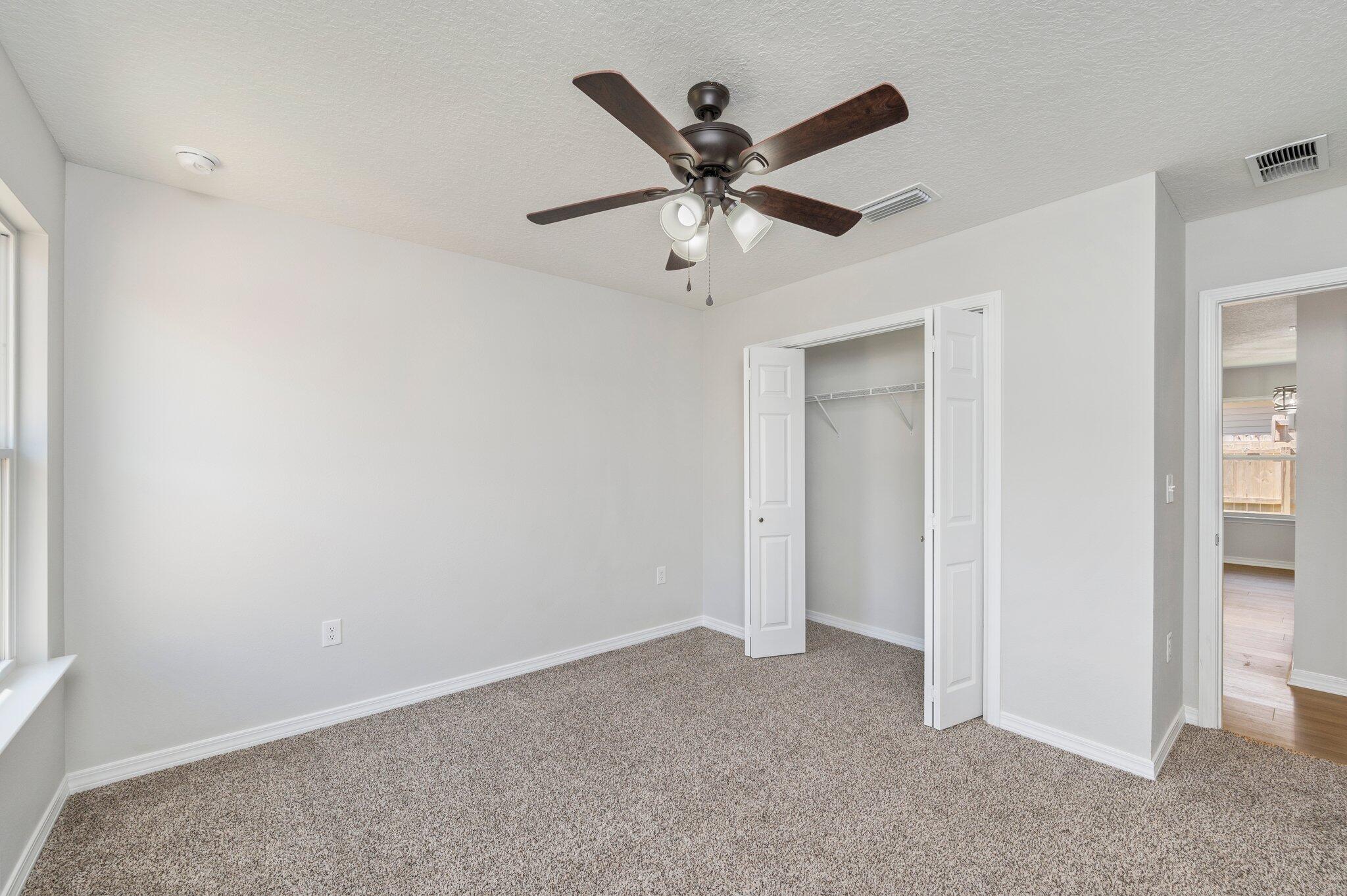 3161 Haskell Langley Road Crestview, FL 32539 - Photo 17 of 36 an empty room with a ceiling fan and window