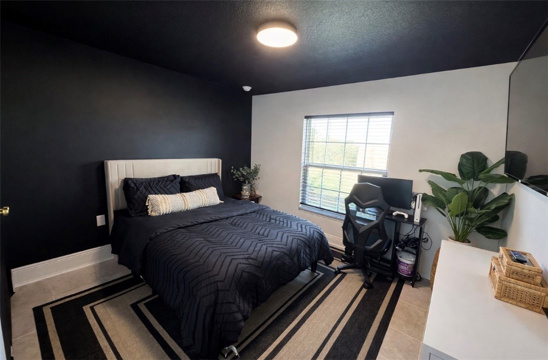 733 Hall Avenue Sebastian, FL 32958 - Photo 11 of 21 a bedroom with a bed table chair and a window
