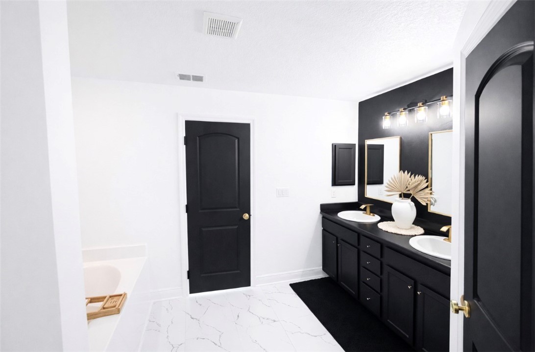 733 Hall Avenue Sebastian, FL 32958 - Photo 16 of 21 a bathroom with a double vanity sink and mirror