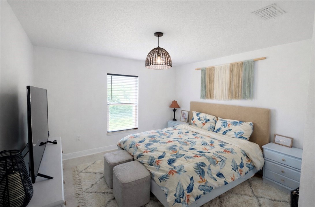 733 Hall Avenue Sebastian, FL 32958 - Photo 7 of 21 a bedroom with a bed and a flat screen tv