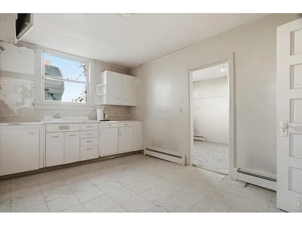 a kitchen with white cabinets