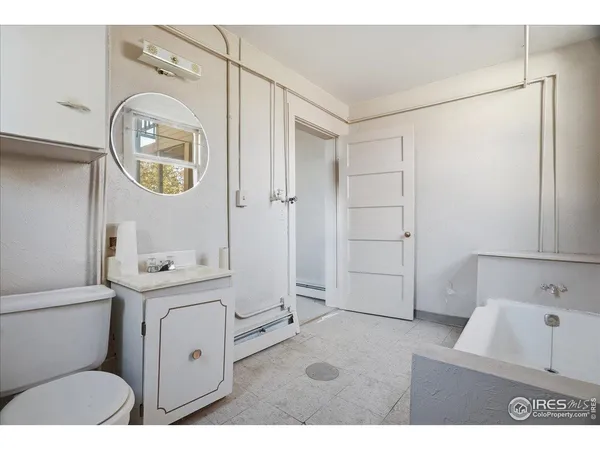 a bathroom with a toilet a sink and a mirror