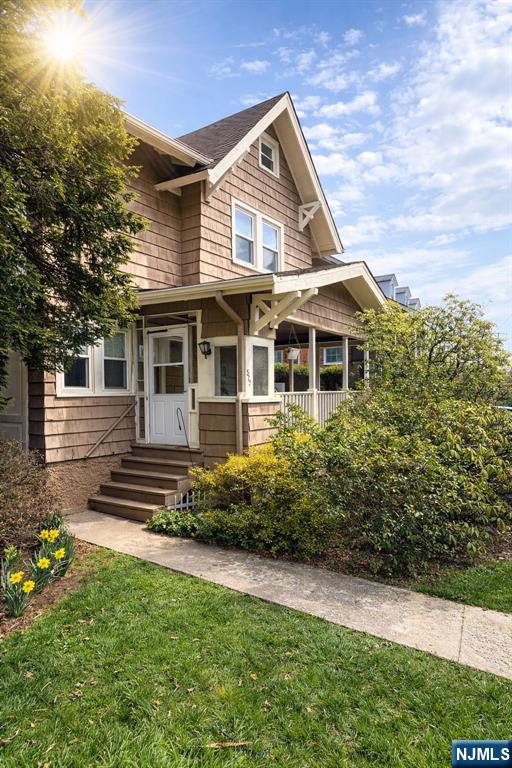 327 Rutland Avenue Teaneck, NJ 07666 - Photo 3 of 12 a front view of a house with a garden
