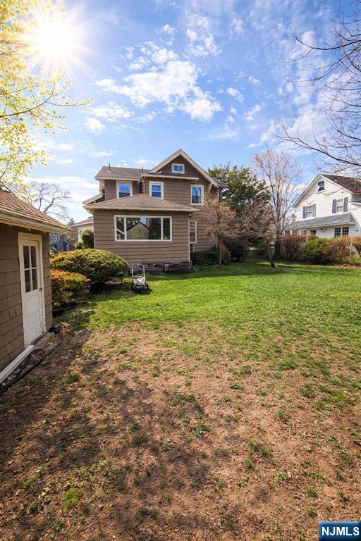 327 Rutland Avenue Teaneck, NJ 07666 - Photo 5 of 12 a front view of a house with a garden