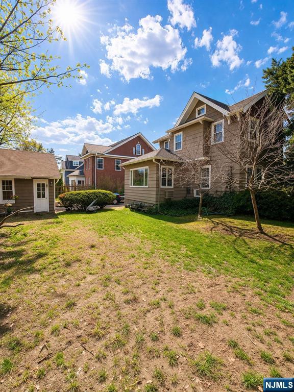 327 Rutland Avenue Teaneck, NJ 07666 - Photo 6 of 12 a front view of a house with a yard