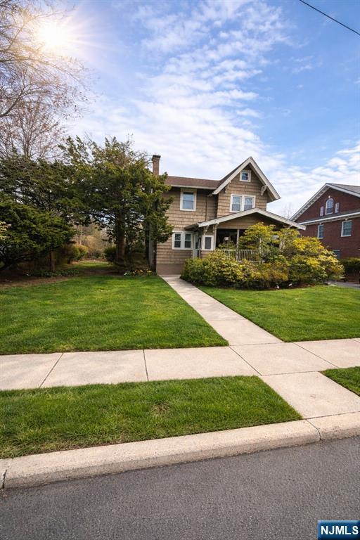 327 Rutland Avenue Teaneck, NJ 07666 - Photo 10 of 12 a front view of a house with a yard and garage