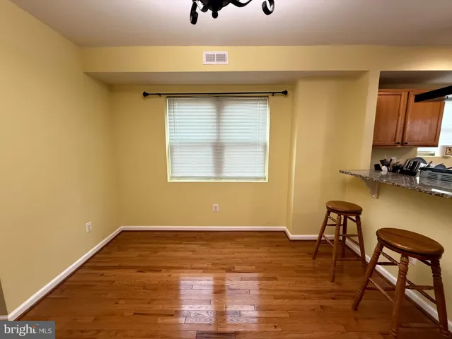 a view of a kitchen with kitchen island stainless steel appliances refrigerator stove microwave and cabinets