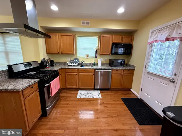 a kitchen with refrigerator and furniture