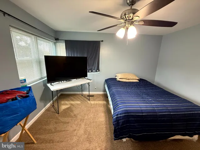 a view of utility room with closet and wooden floor
