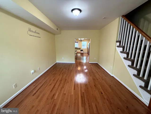 a view of a kitchen with wooden floor and a kitchen
