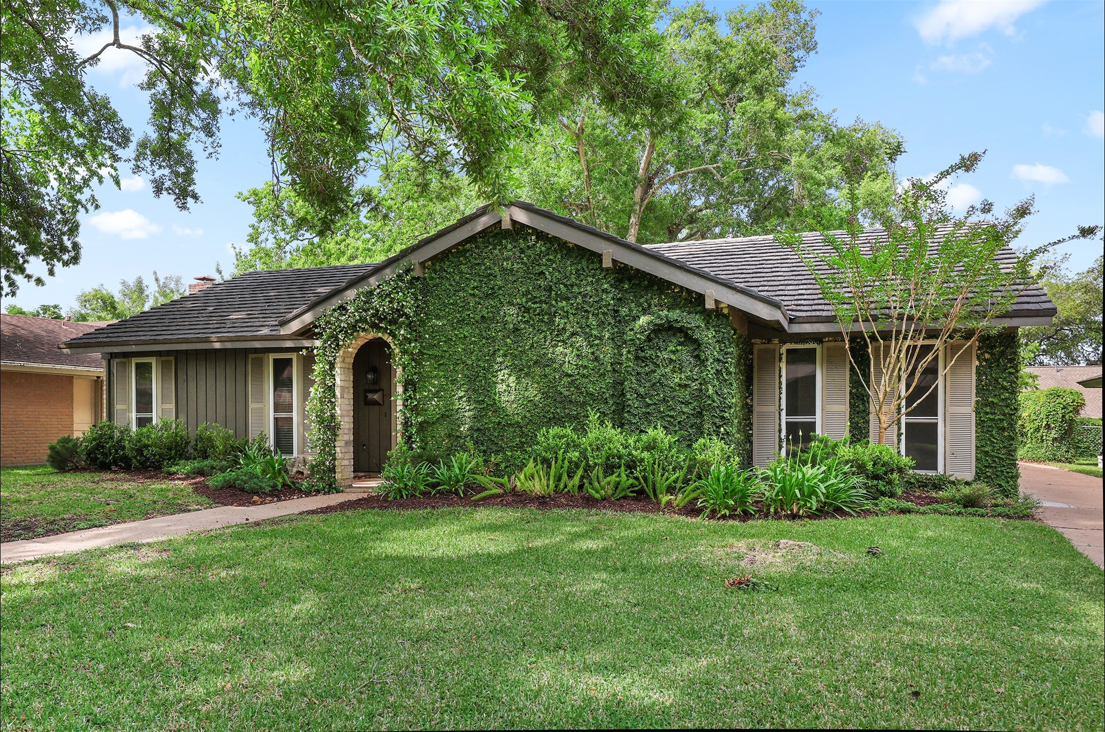 18306 Barbuda Lane Houston, TX 77058 - Photo 1 of 25 a front view of a house with a garden