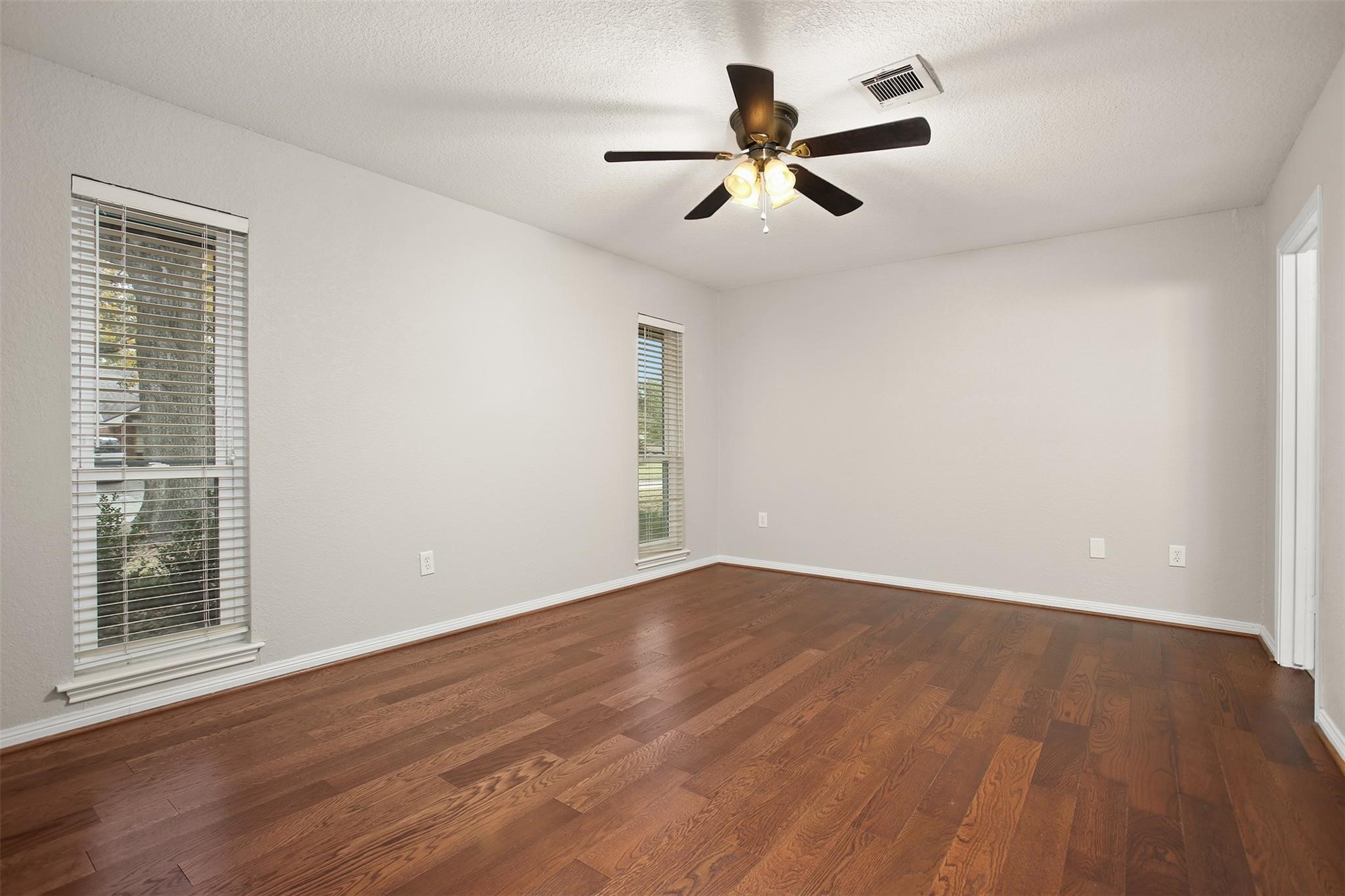 18306 Barbuda Lane Houston, TX 77058 - Photo 14 of 25 a view of a big room with wooden floor and windows