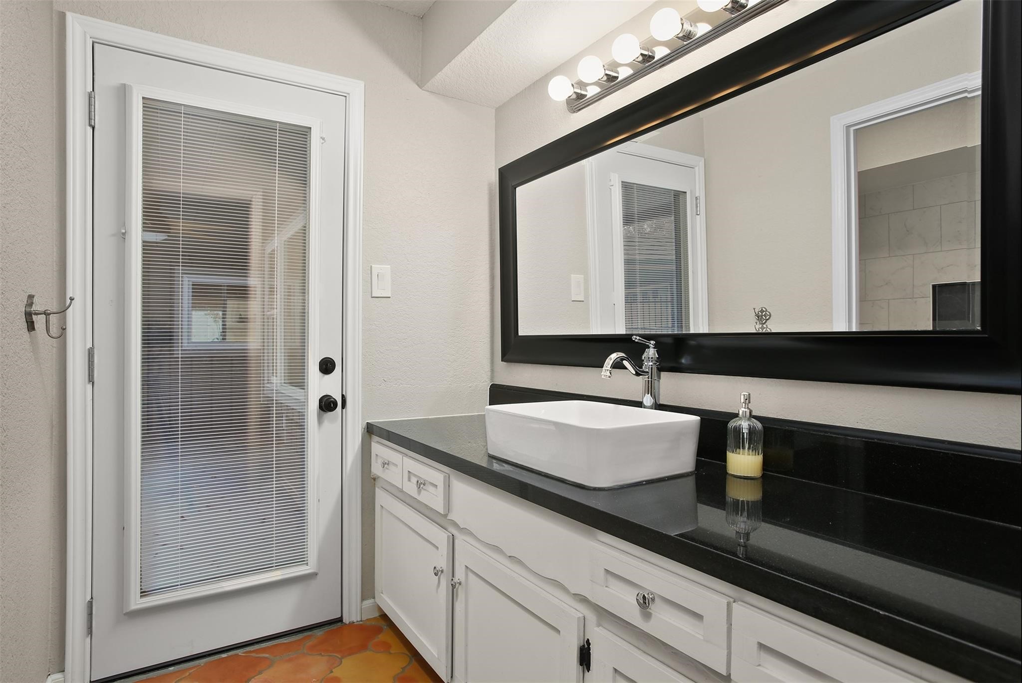 18306 Barbuda Lane Houston, TX 77058 - Photo 18 of 25 a bathroom with a sink and a mirror