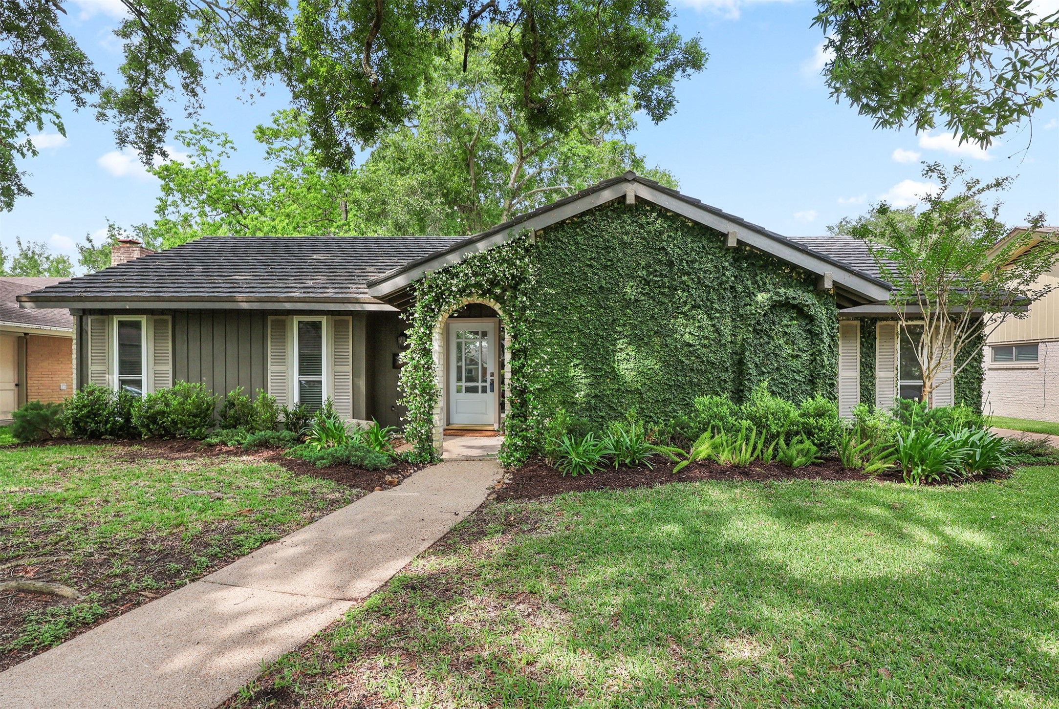 18306 Barbuda Lane Houston, TX 77058 - Photo 24 of 25 a front view of a house with a yard and trees