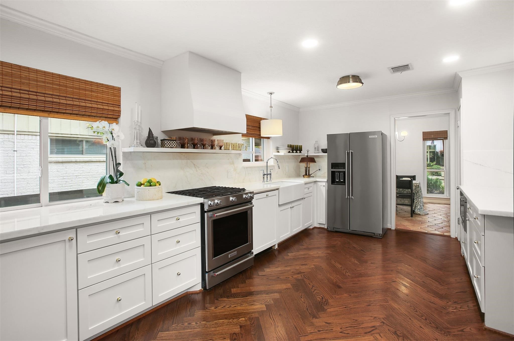18306 Barbuda Lane Houston, TX 77058 - Photo 6 of 25 a kitchen with white cabinets and stainless steel appliances