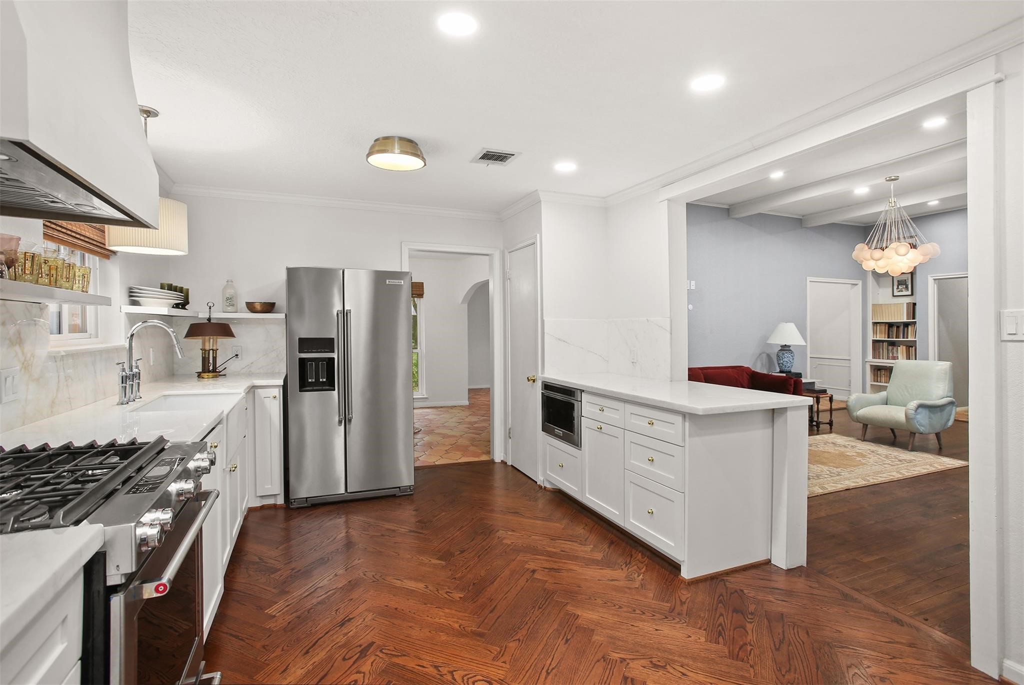 18306 Barbuda Lane Houston, TX 77058 - Photo 7 of 25 a kitchen with white cabinets and stainless steel appliances