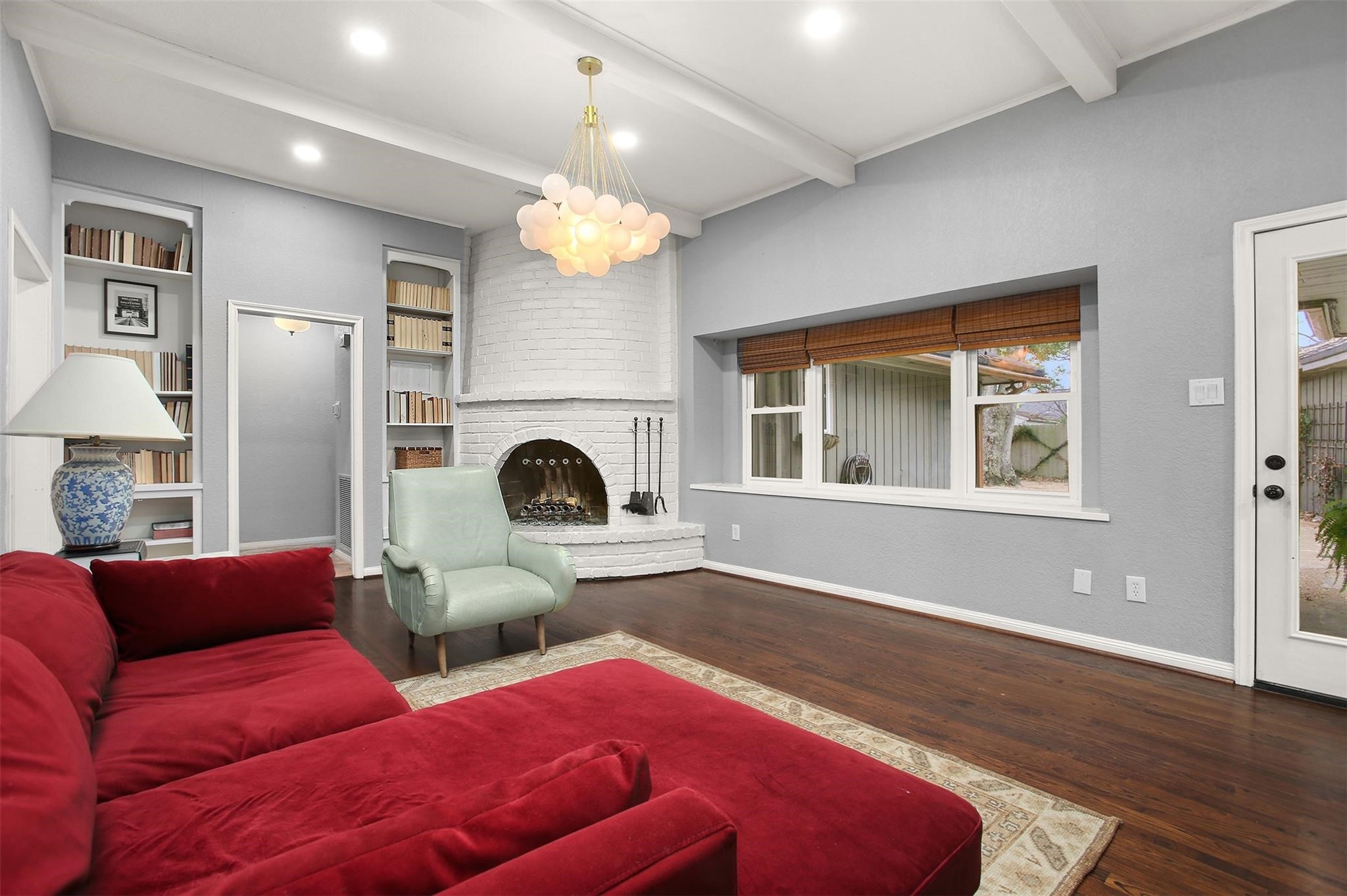 18306 Barbuda Lane Houston, TX 77058 - Photo 10 of 25 a living room with furniture a fireplace and a chandelier