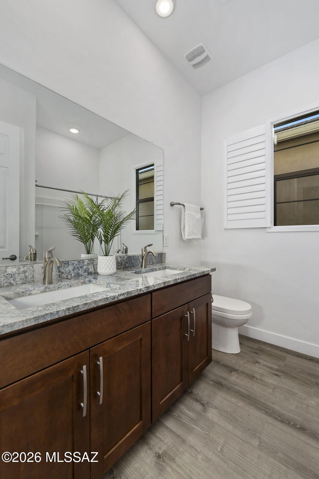 12791 East Tortoise Pointe Drive Vail, AZ 85641 - Photo 36 of 50 a bathroom with a granite countertop sink a toilet and mirror