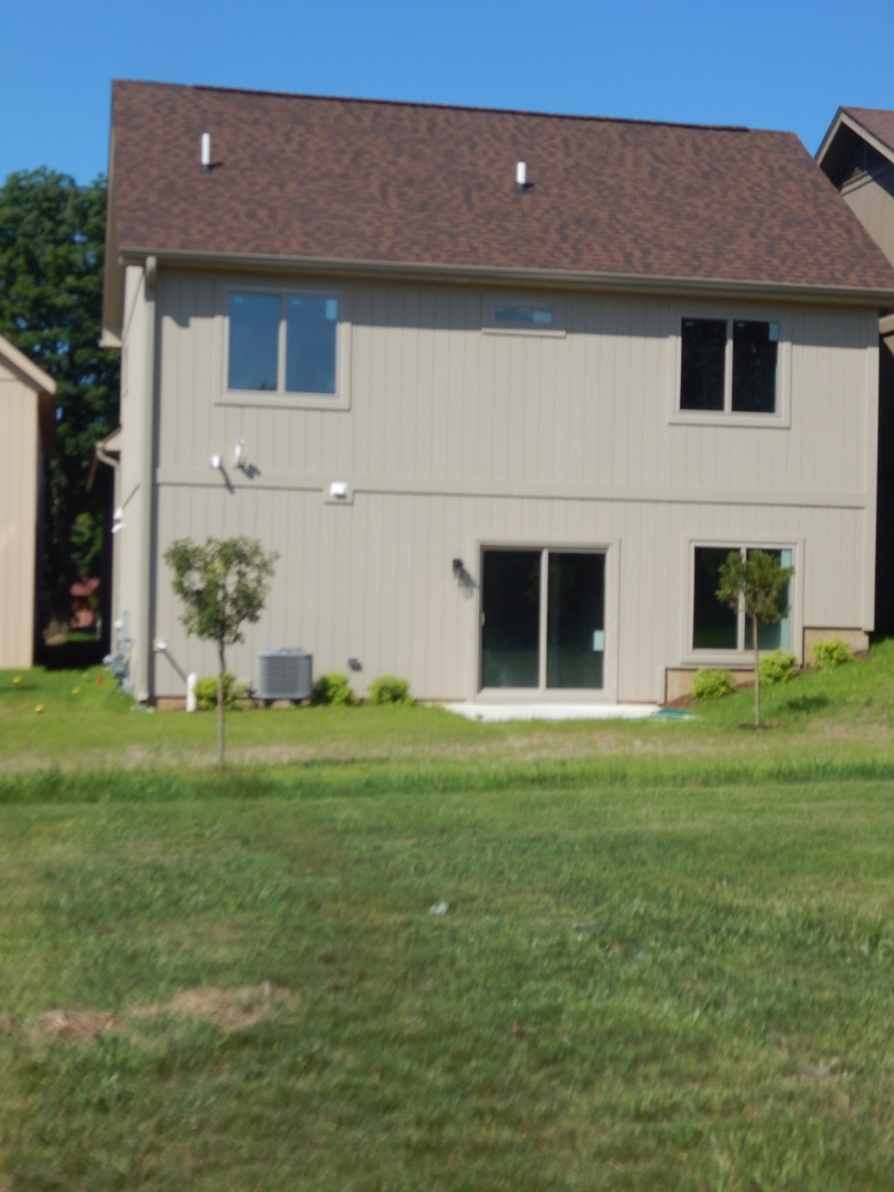 5912 Prairie Ridge Road Crystal Lake, IL 60014 - Photo 21 of 23 a front view of house with a garden
