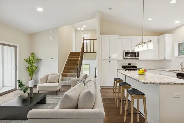 a living room with furniture and a kitchen view