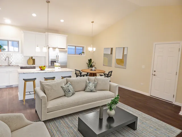 a living room with furniture and kitchen view