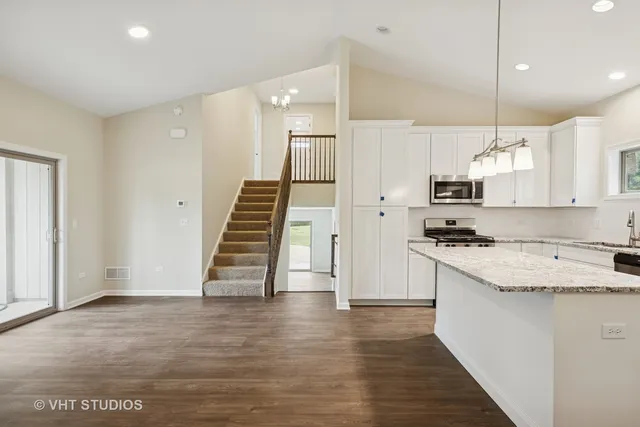 a view of kitchen with sink and refrigerator