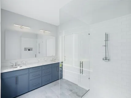 a spacious bathroom with a granite countertop sink mirror and double