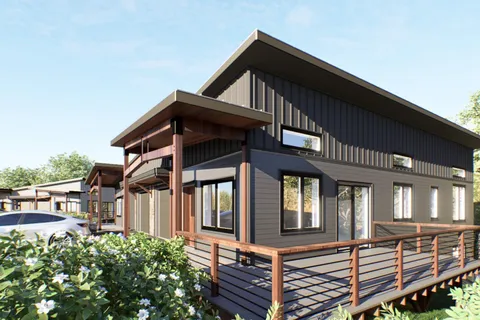 a view of a house with a small yard and wooden floor and fence