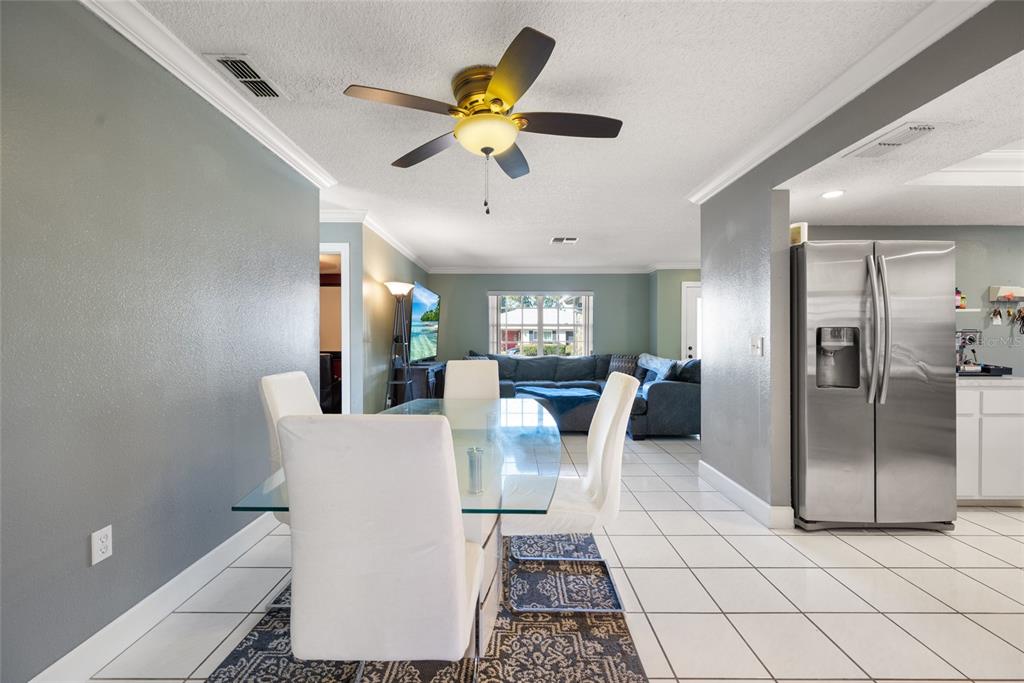 8714 Martinique Lane Port Richey, FL 34668 - Photo 13 of 34 a living room with stainless steel appliances furniture and a chandelier