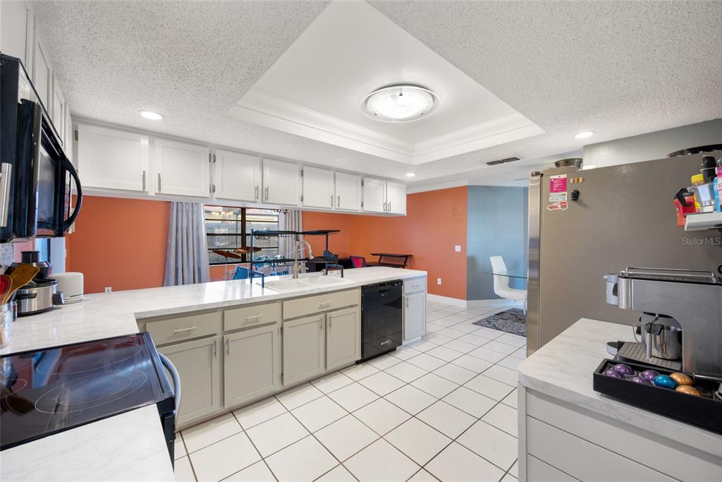 8714 Martinique Lane Port Richey, FL 34668 - Photo 18 of 34 a kitchen with granite countertop cabinets stainless steel appliances and a sink