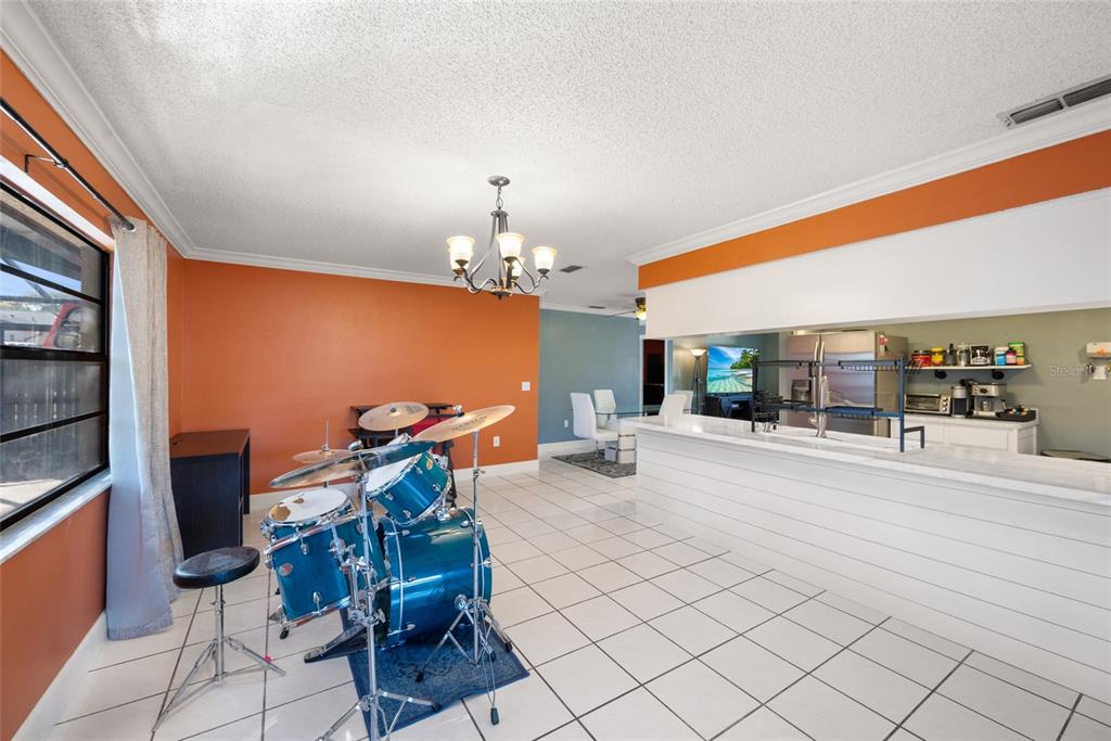 8714 Martinique Lane Port Richey, FL 34668 - Photo 21 of 34 a living room with furniture a dining table and chairs with wooden floor