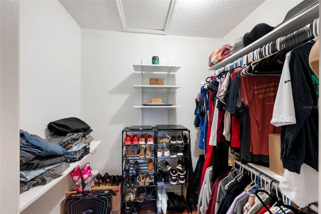 8714 Martinique Lane Port Richey, FL 34668 - Photo 25 of 34 a view of walk in closet with clothes and shoes