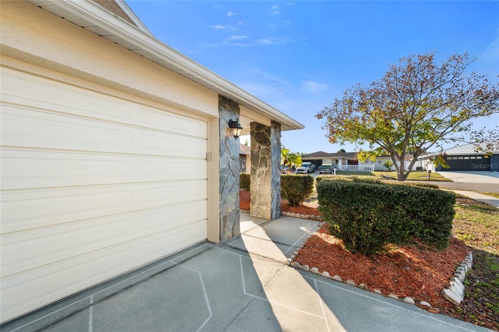 8714 Martinique Lane Port Richey, FL 34668 - Photo 5 of 34 a front view of a house with a yard