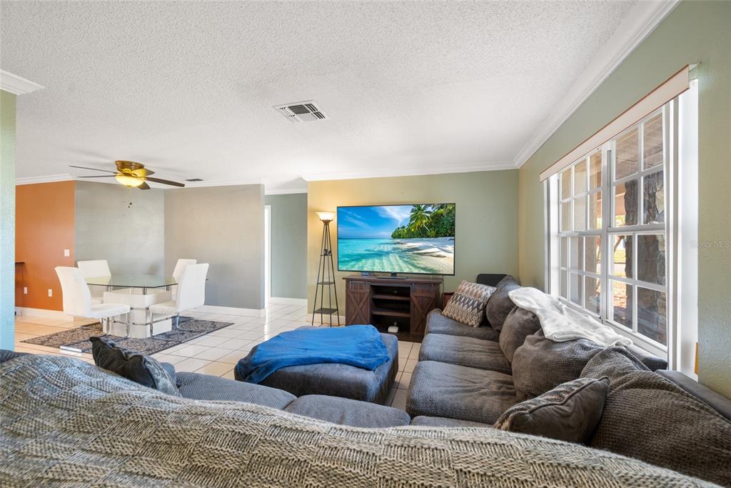 8714 Martinique Lane Port Richey, FL 34668 - Photo 7 of 34 a living room with furniture and a flat screen tv